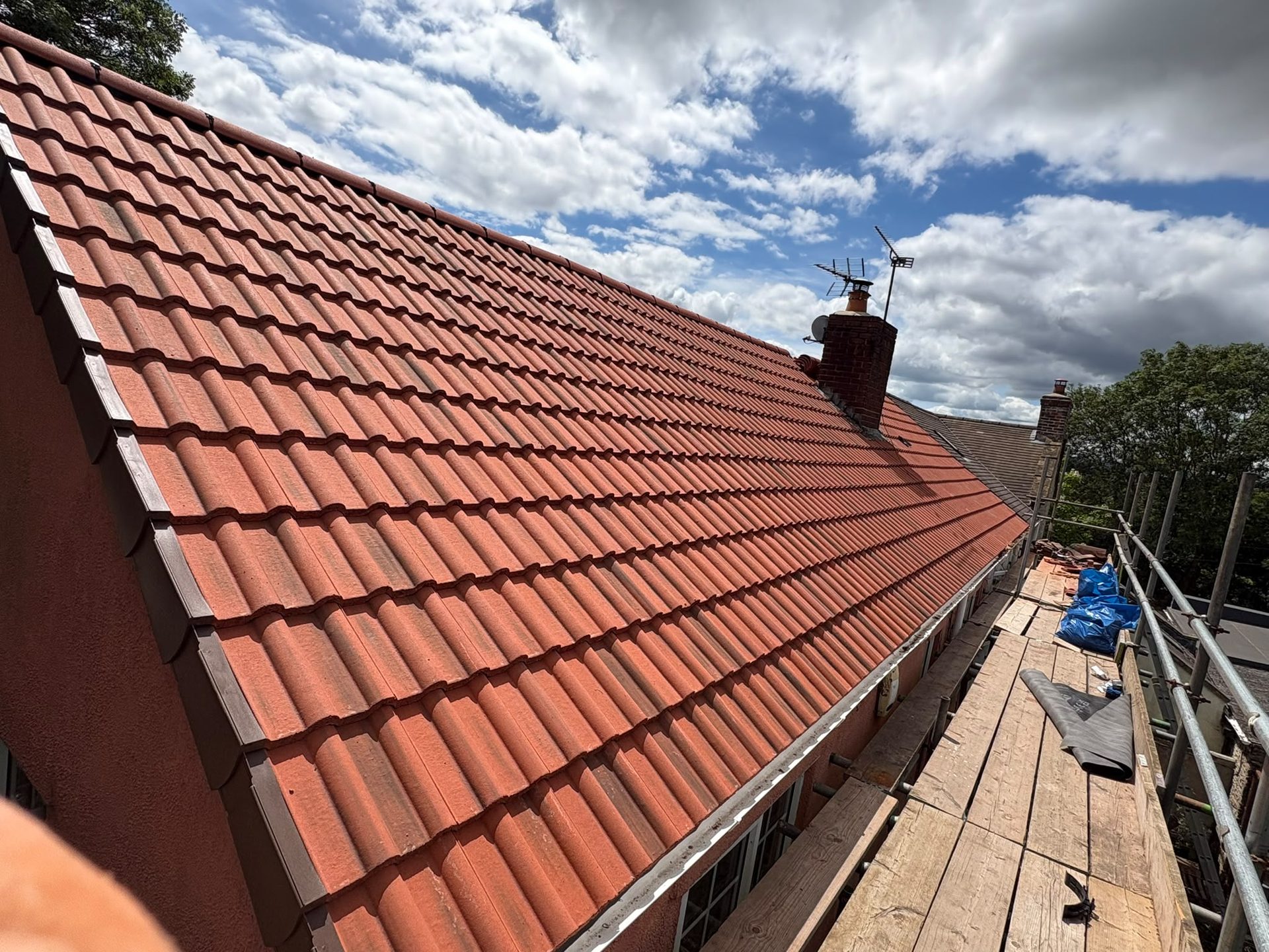 Completed red tile re-roof with dry verge and chimney, new roof in Glastonbury, Somerset
