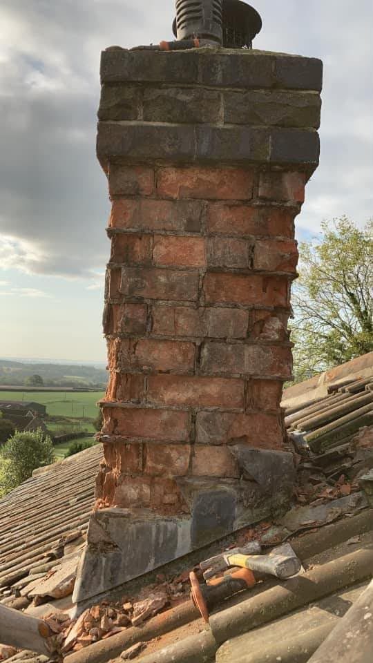 Crumbling brick chimney stack before repair, showing failed pointing on a Somerset roof