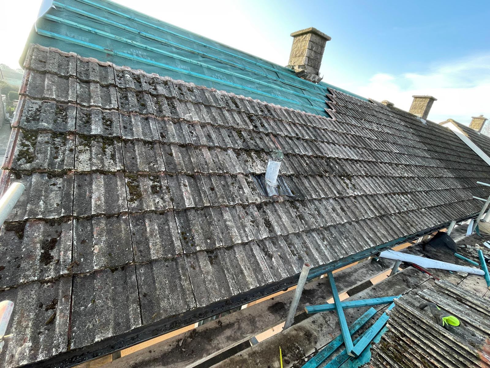 Mossy concrete tiles being replaced with new membrane and battens above, re-roof in Somerset