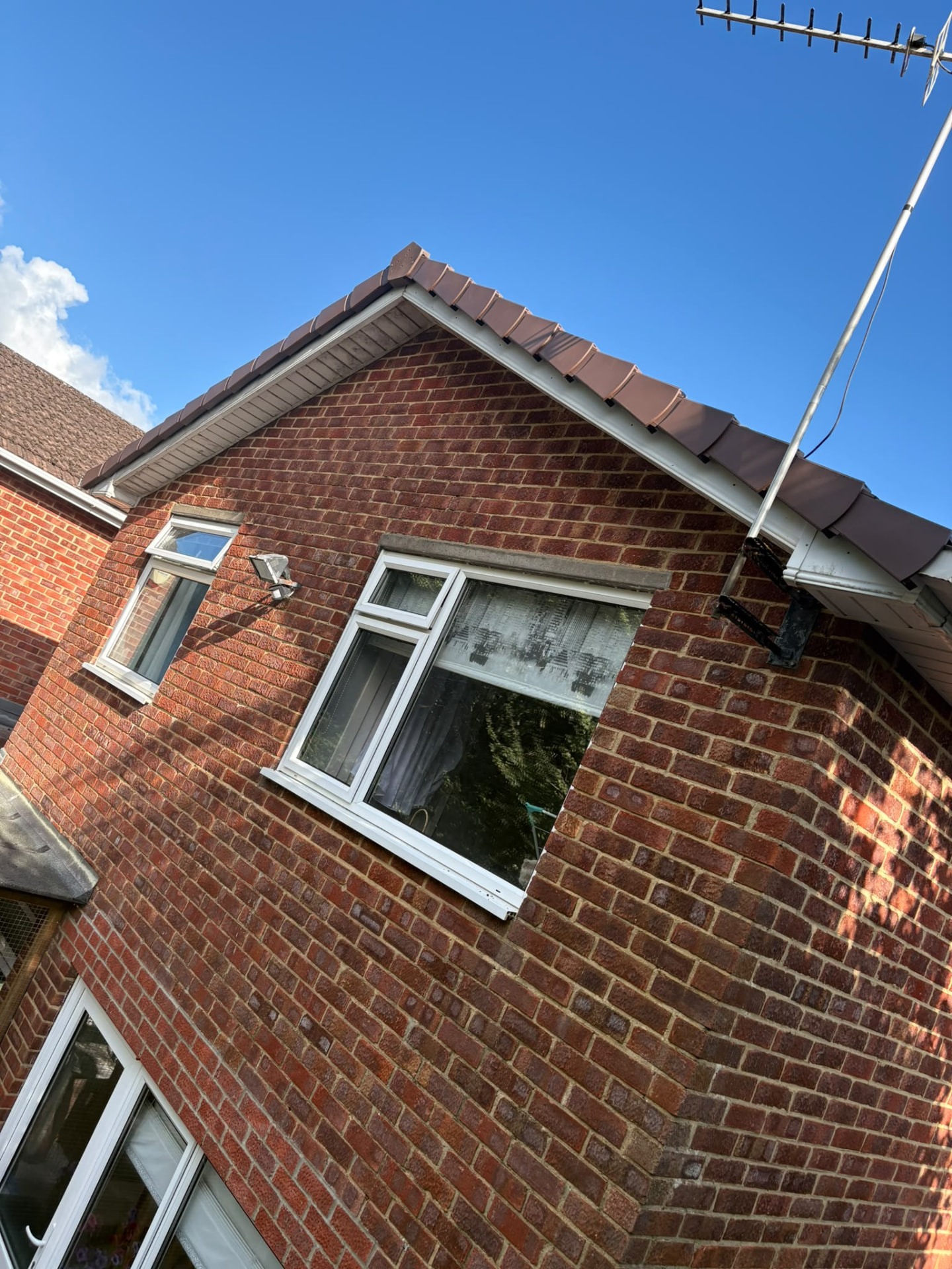 Brick gable with new white fascias, soffits and dry verge, Somerset