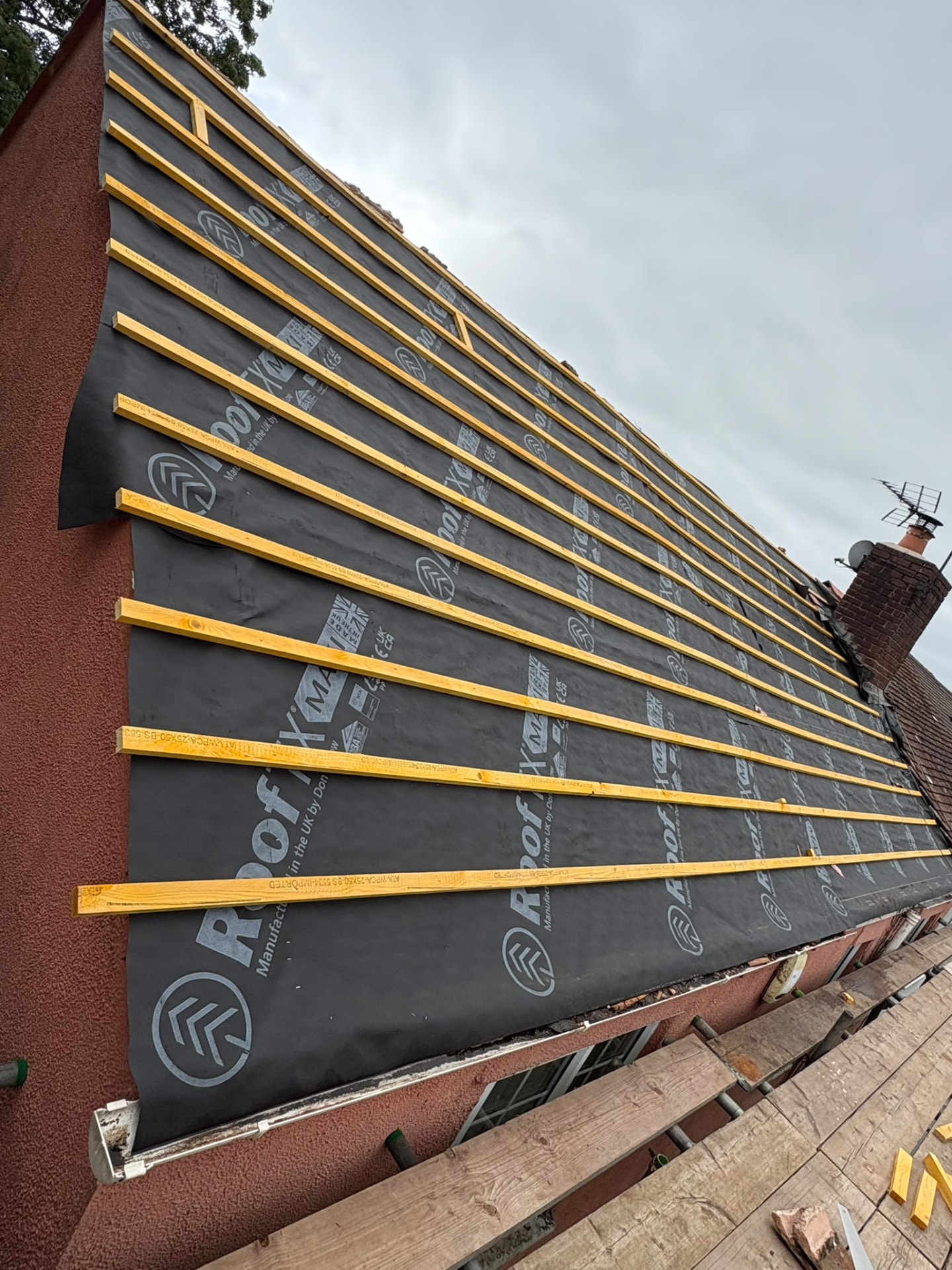 Long roof slope battened over new membrane ready for tiles, re-roofing Glastonbury