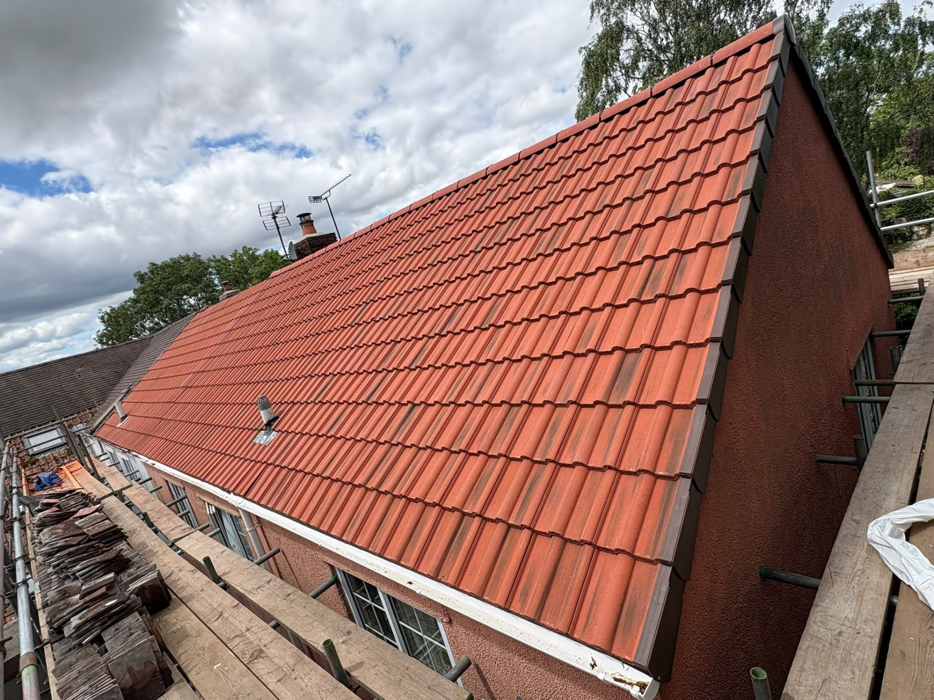 Completed red tile re-roof with dry verge, seen from the scaffold, Somerset