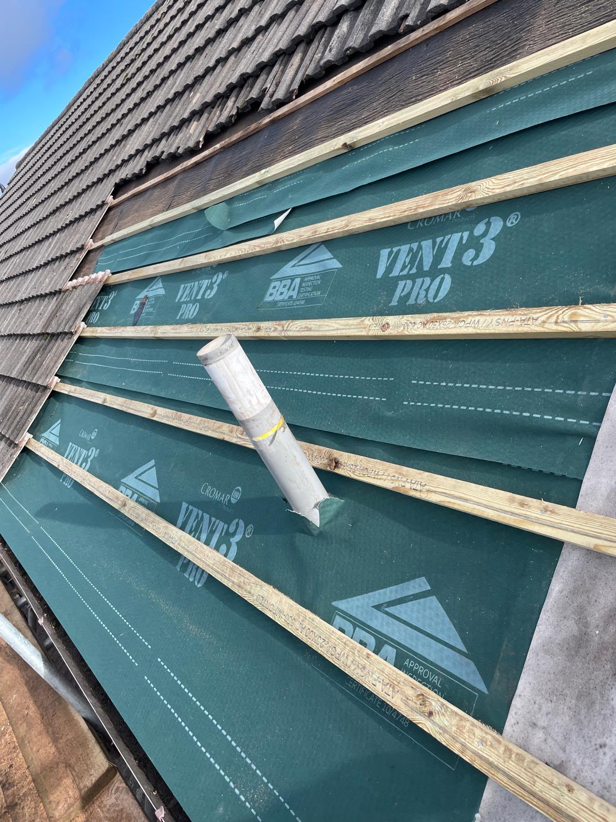 Membrane and battens fitted around a soil vent pipe during a re-roof, Glastonbury