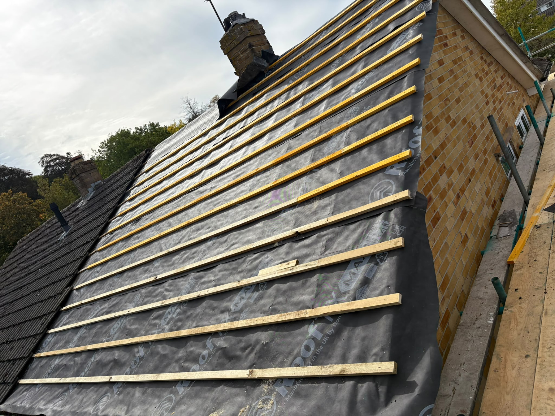 New breathable membrane and timber battens across a full roof slope during a re-roof, Somerset