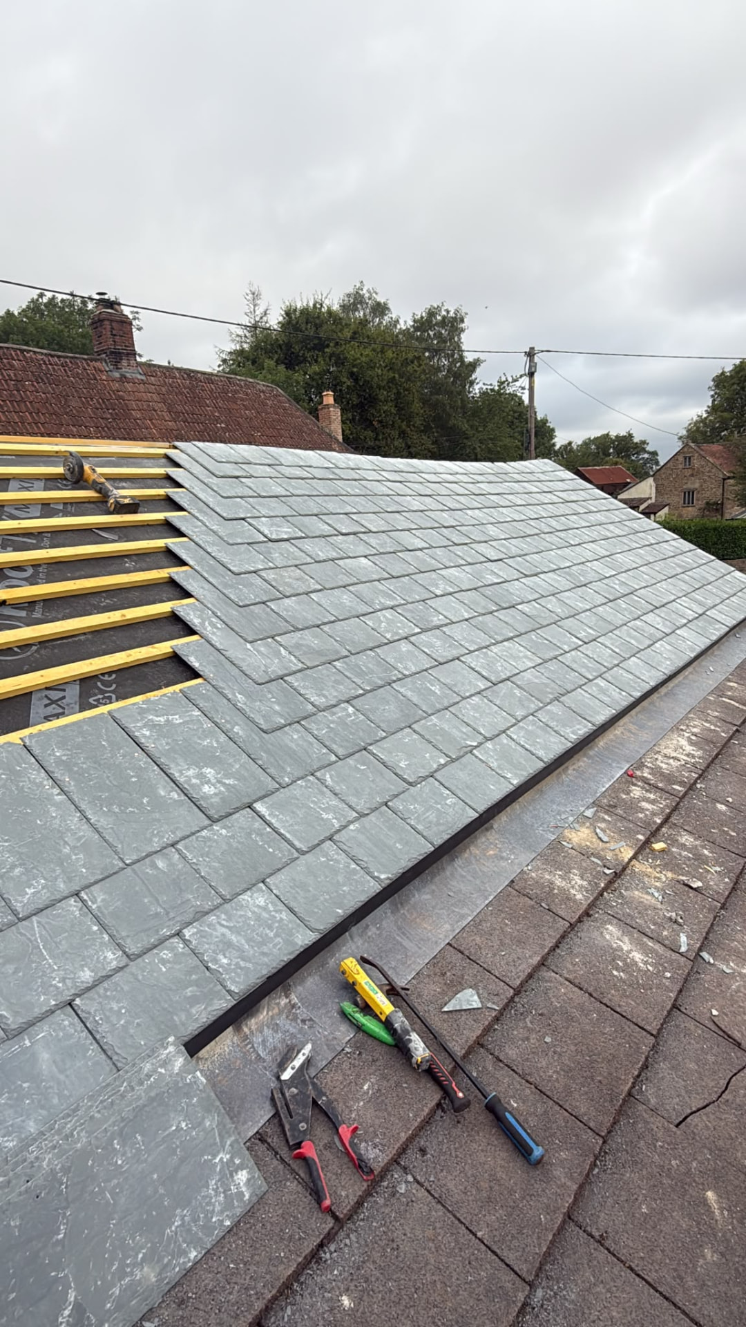 New natural slate being laid over fresh battens, slate re-roof in Somerset