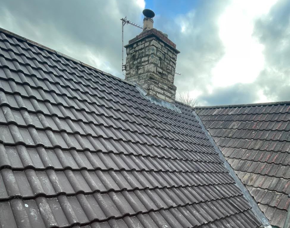 New lead valley and chimney flashing between two tiled roof slopes, leadwork in Glastonbury