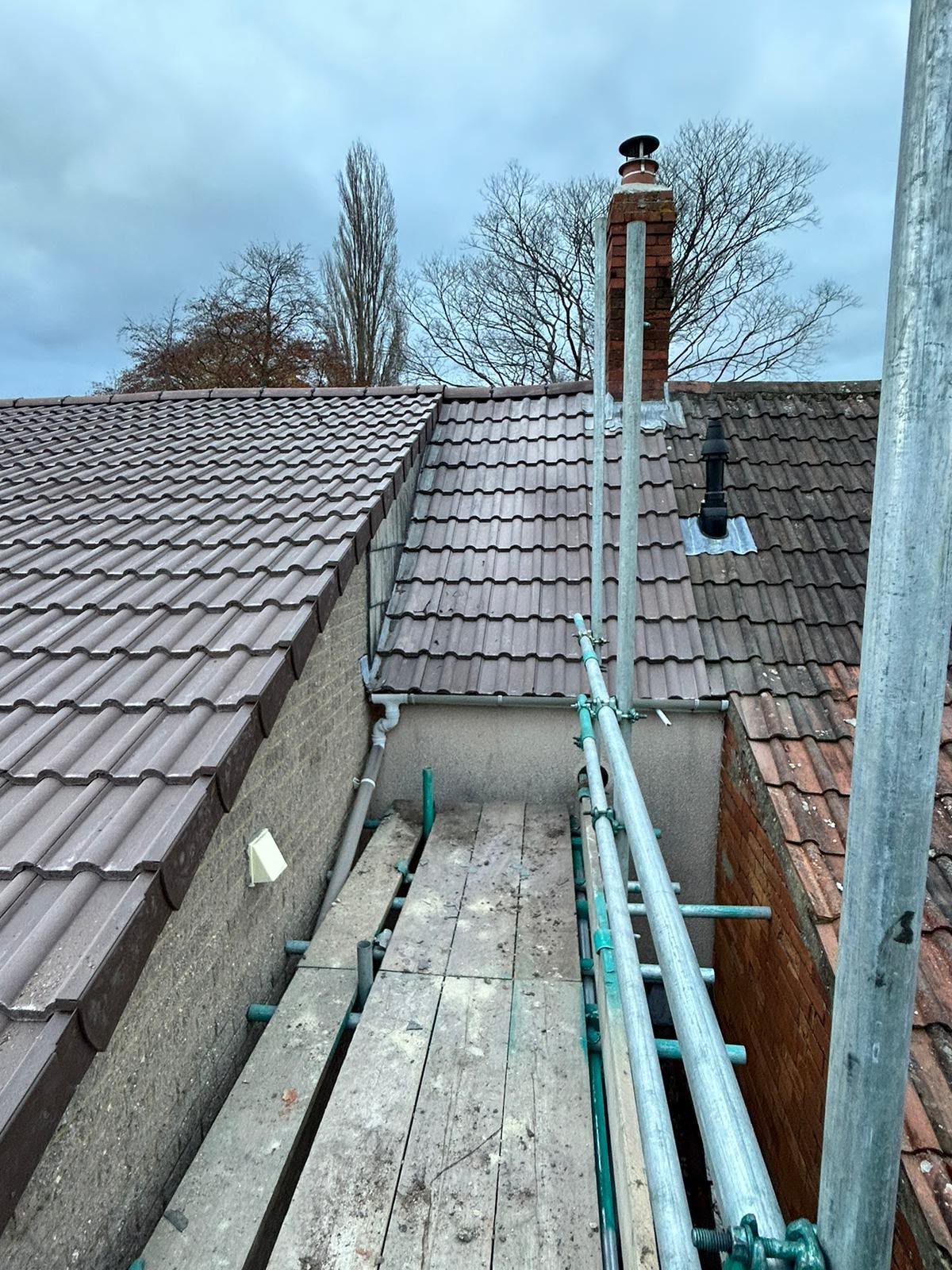 Completed brown tile re-roof with new lead flashings at the chimney, Glastonbury