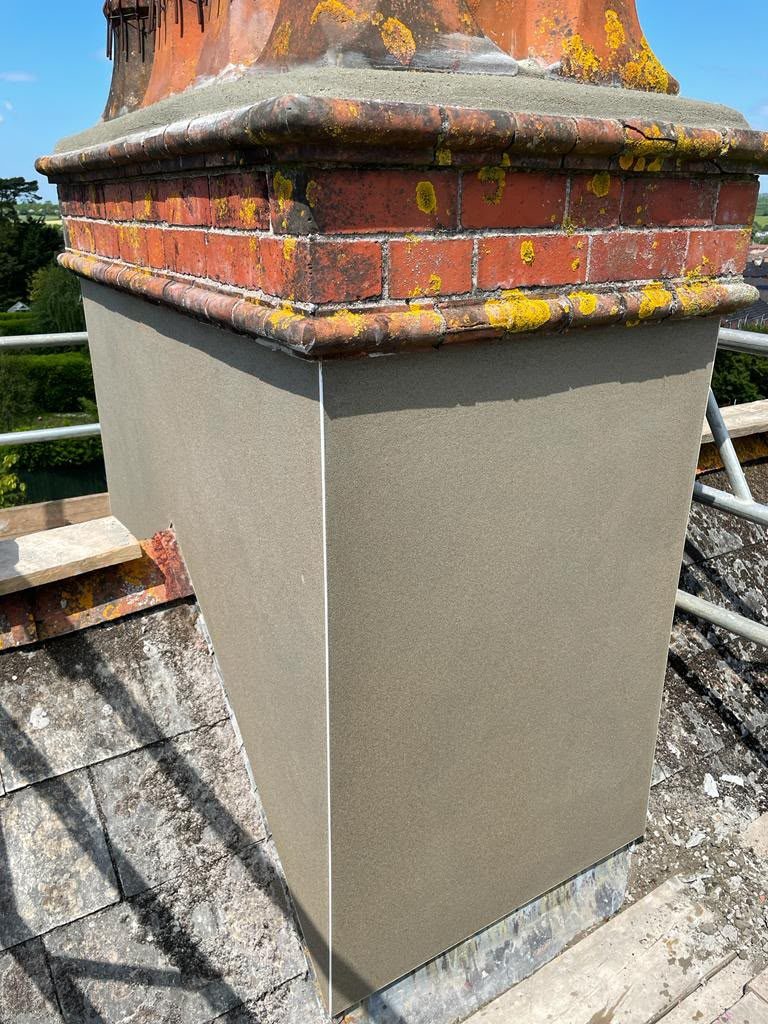Chimney stack freshly rendered with new flaunching, chimney repairs in Glastonbury, Somerset